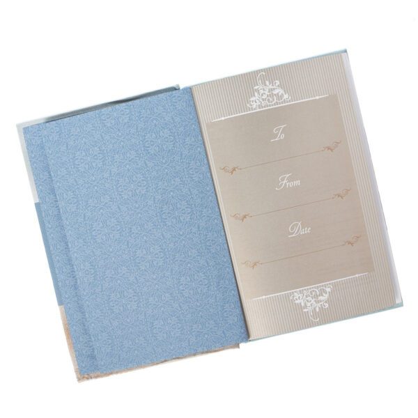 Here's an alt tag for the image: Open blue guest book, to, from, date.