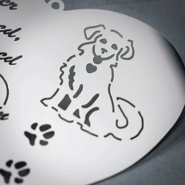 Metal dog ornament, paw prints.